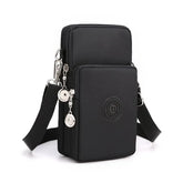 Black crossbody bag with a strap and decorative elements on a white background