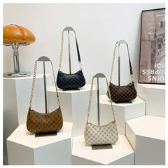 Four handbags displayed on a white surface with a neutral background