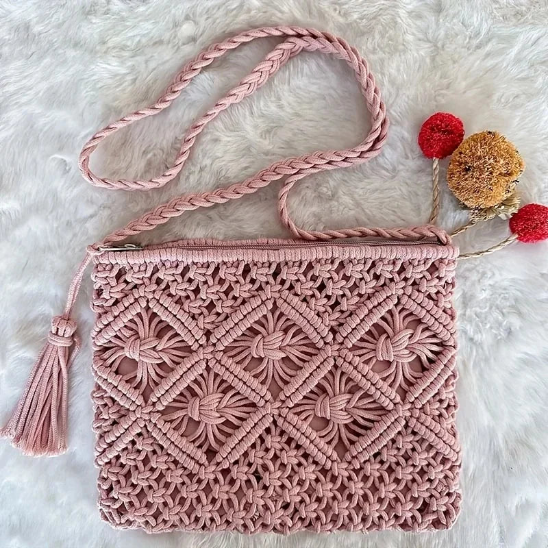 Pink macrame bag with a braided strap on a white fluffy background