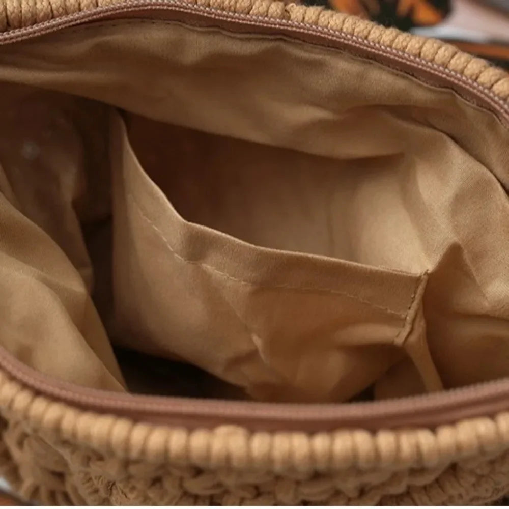 Close-up of the interior of a woven bag, showing a tan fabric lining with a zip-around top and a side pocket.