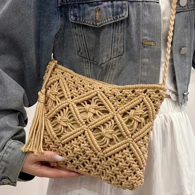 Beige woven handbag held by a person wearing a denim jacket.