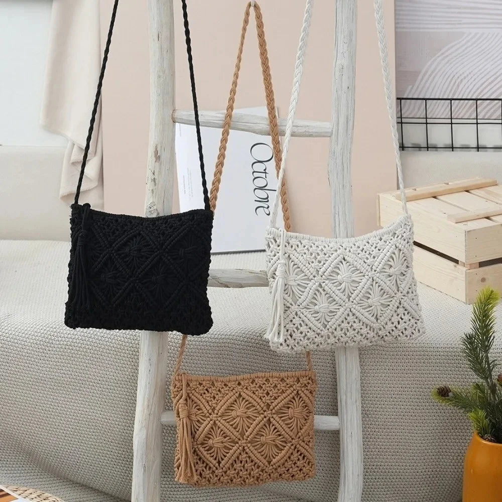 Three woven macrame shoulder bags in black, off-white, and tan are displayed hanging on a rustic white wooden ladder in a styled room setting.