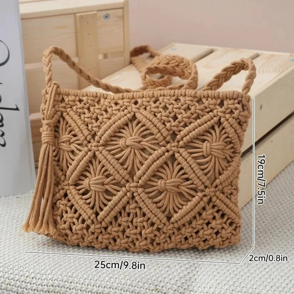 A tan macrame woven handbag with braided shoulder straps and tassel detail, shown on a light textured surface with wooden crates in the background. White dimension lines with text indicate the bag's measurements: 25cm/9.