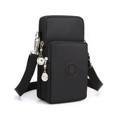 Black crossbody bag with a strap and decorative elements on a white background