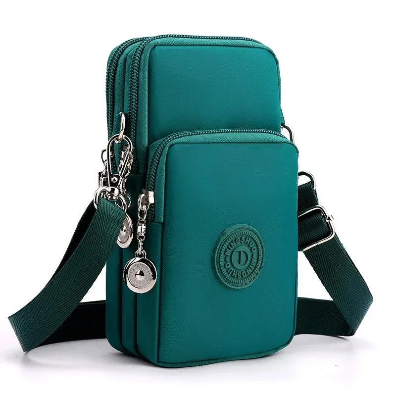 Green crossbody bag with a visible brand logo on a white background