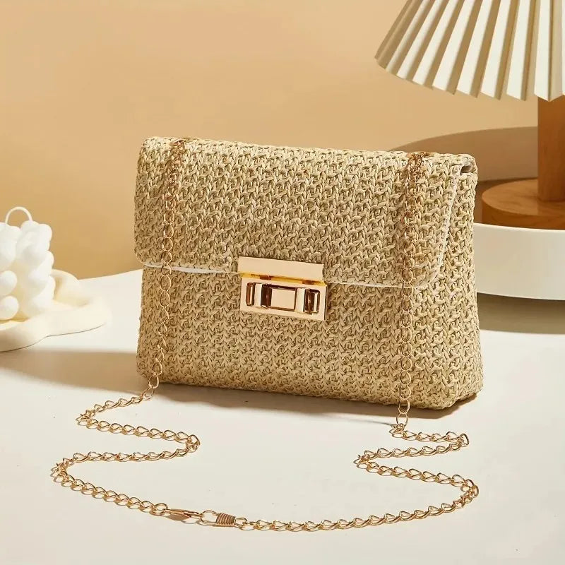 Woven handbag with gold chain strap on a light surface with a neutral background