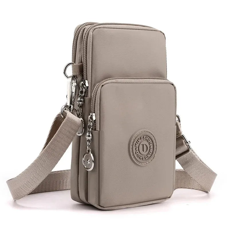 Gray crossbody bag with multiple pockets and a visible brand logo on a white background