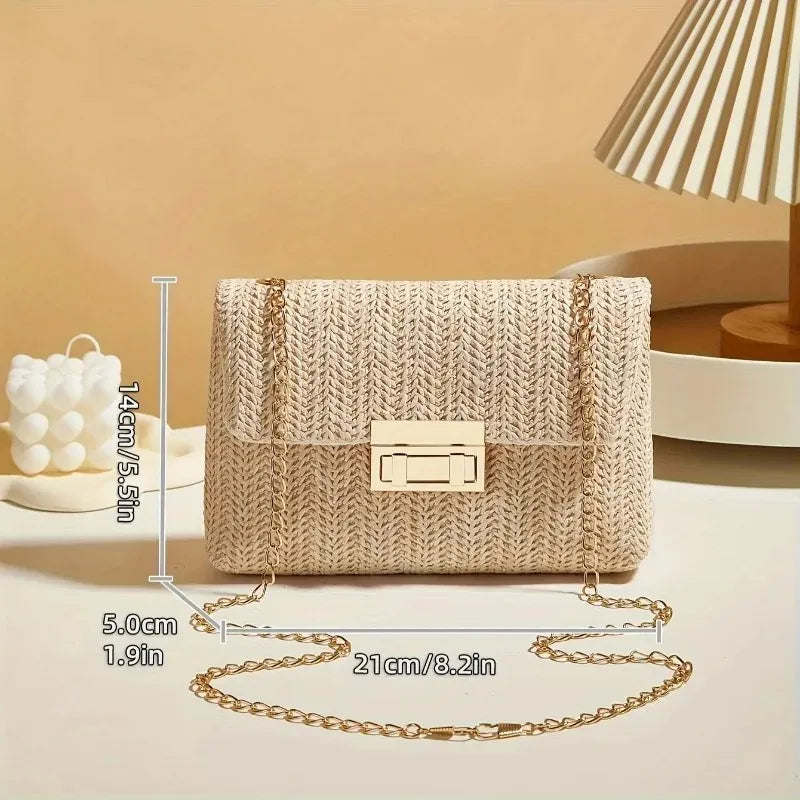 A woven straw-style handbag with a gold-tone chain strap and clasp, shown on a beige tabletop with dimension lines indicating 14 cm height, 21 cm width, and 5 cm strap width.