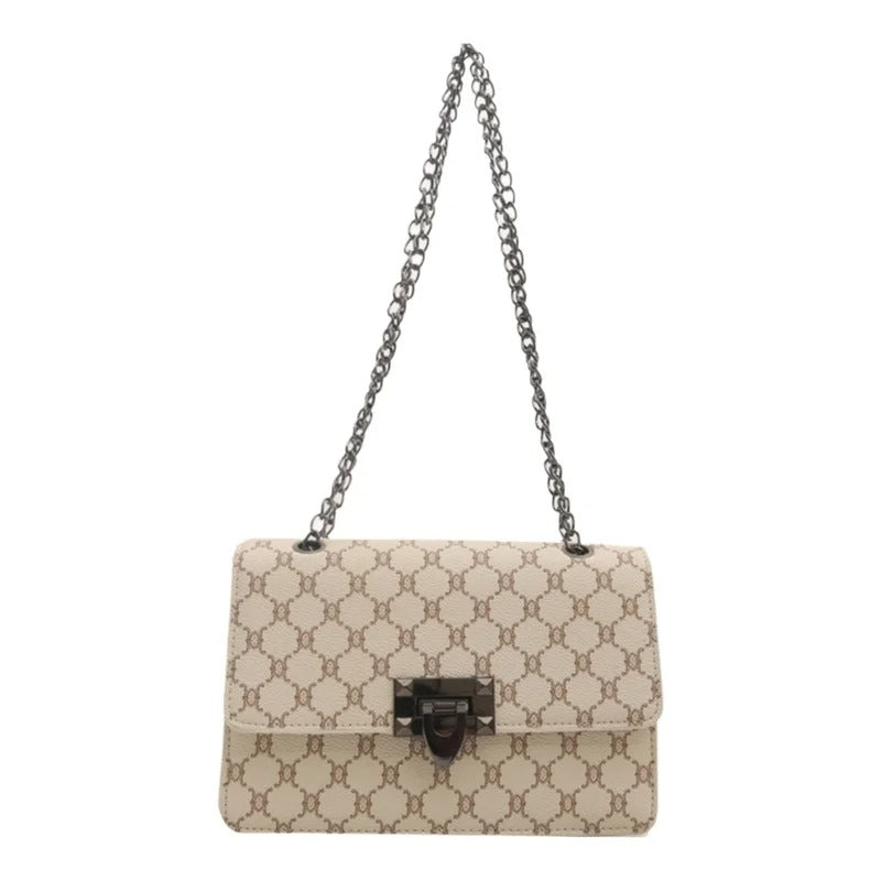 A beige and brown monogram shoulder bag with a dark metal chain strap and a central clasp, shown against a plain white background.