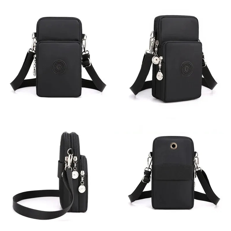 Black crossbody bag with multiple pockets and straps on a white background