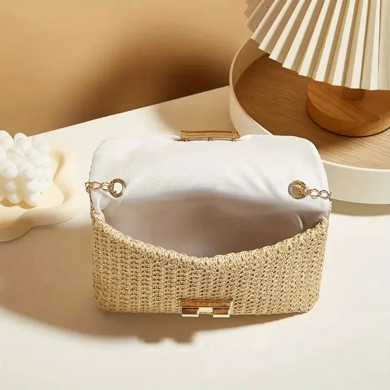 Woven handbag with gold accents on a neutral background