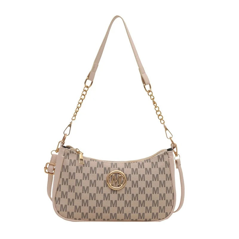 Beige handbag with gold chain strap on a white background