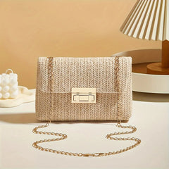 Beige woven handbag with a gold chain strap on a neutral background