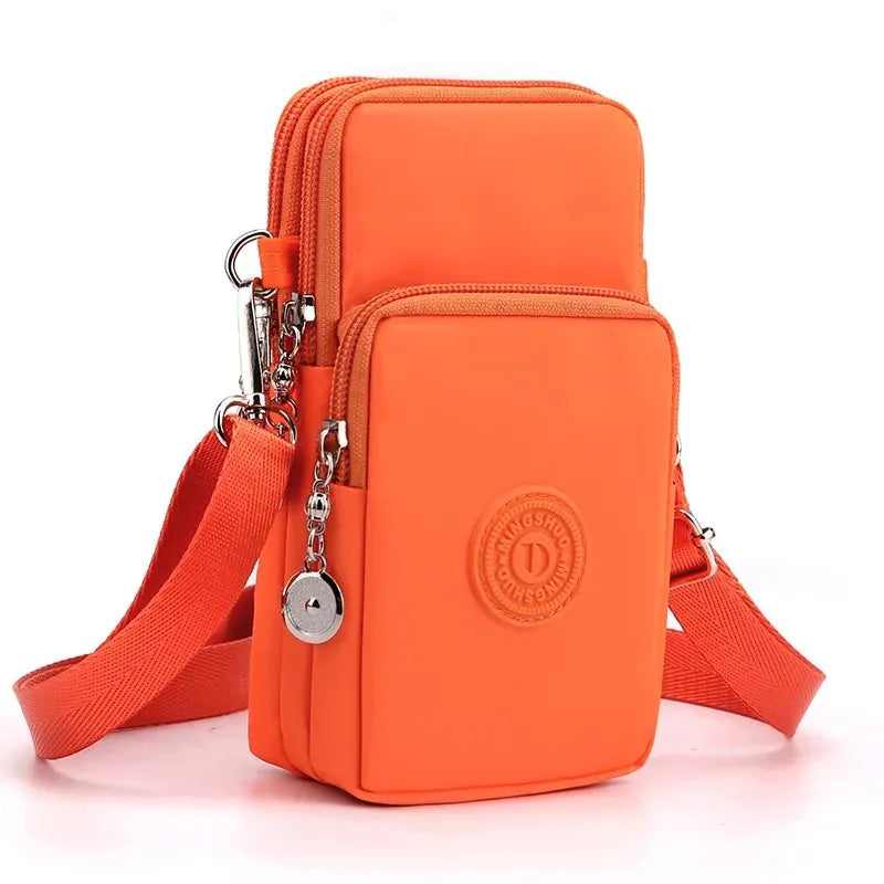 Orange crossbody bag with a strap on a white background